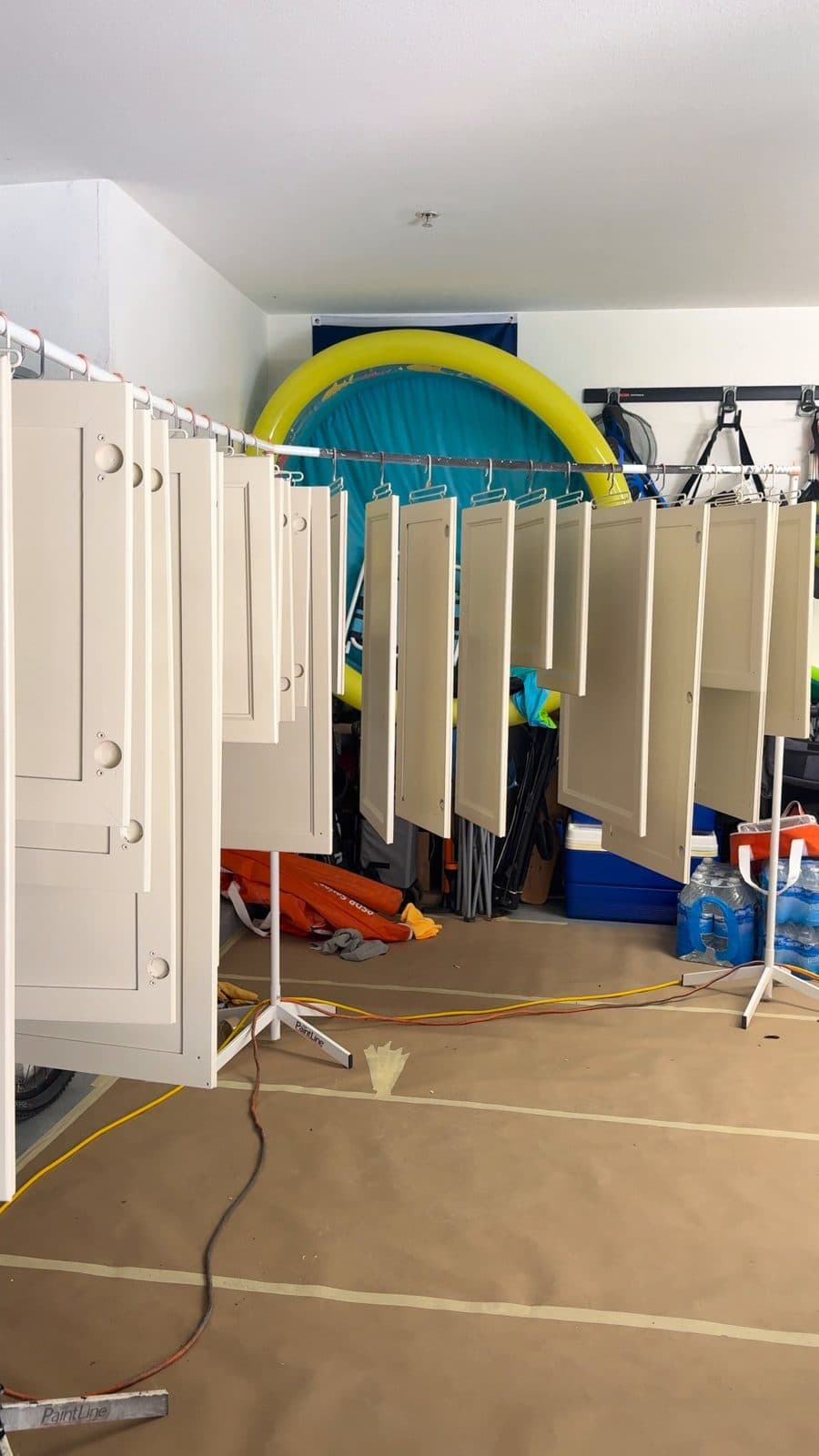Cabinet doors drying on a rack after spraying
