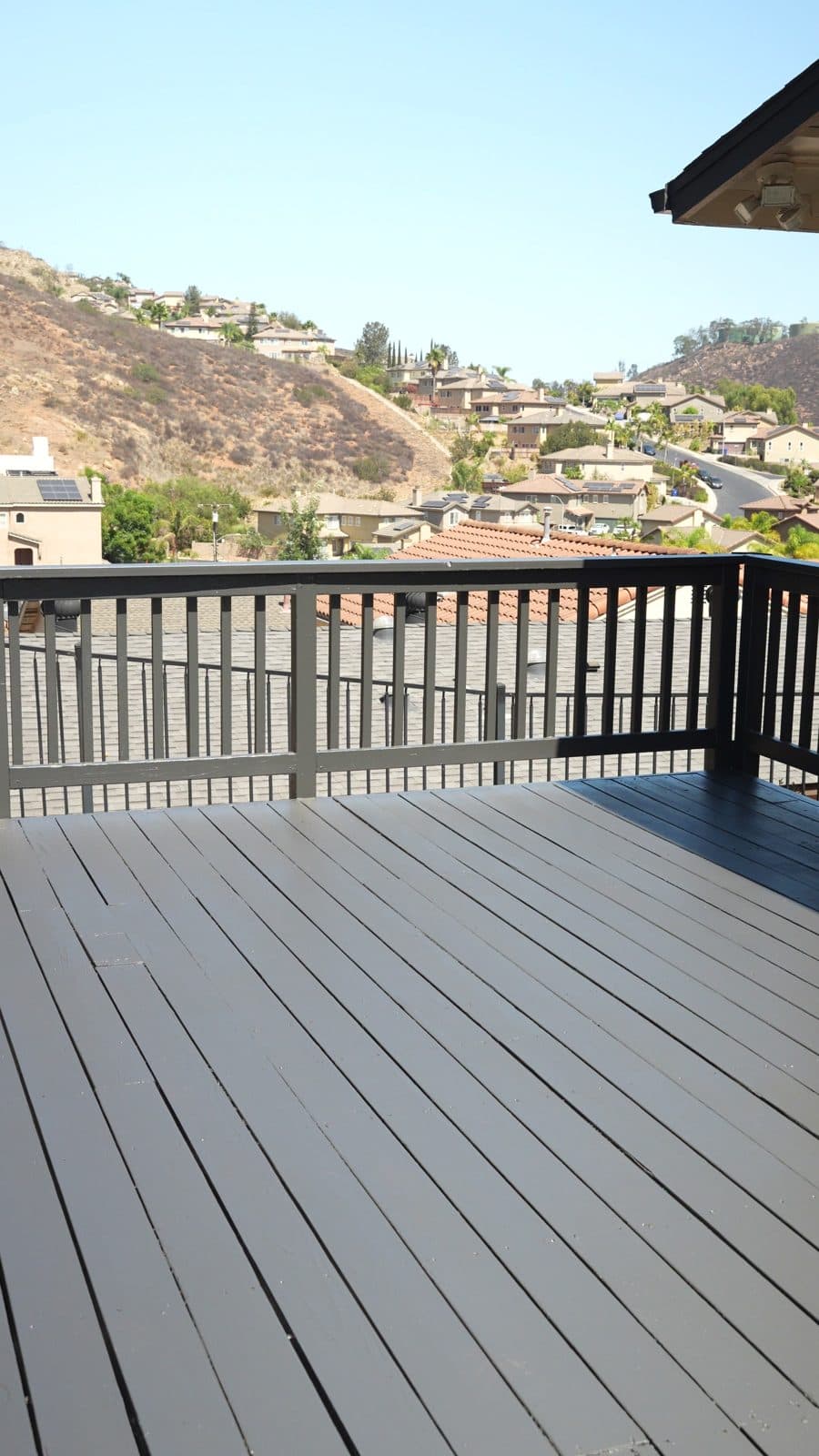 Refinished deck and railing with a hillside view