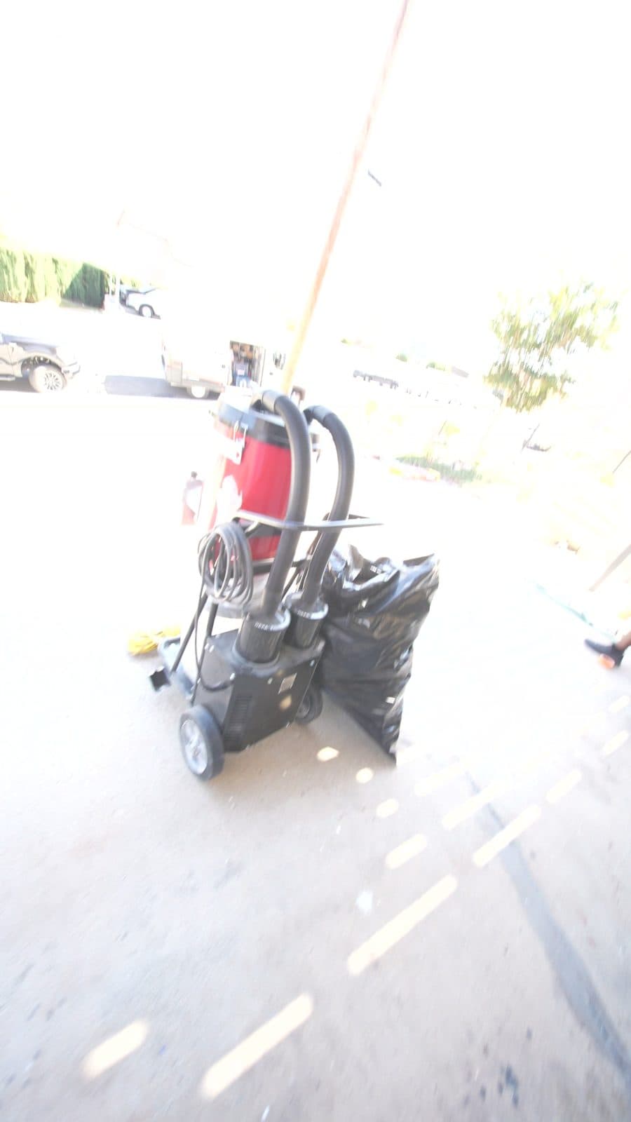 Bare concrete and grinder before the epoxy floor went down