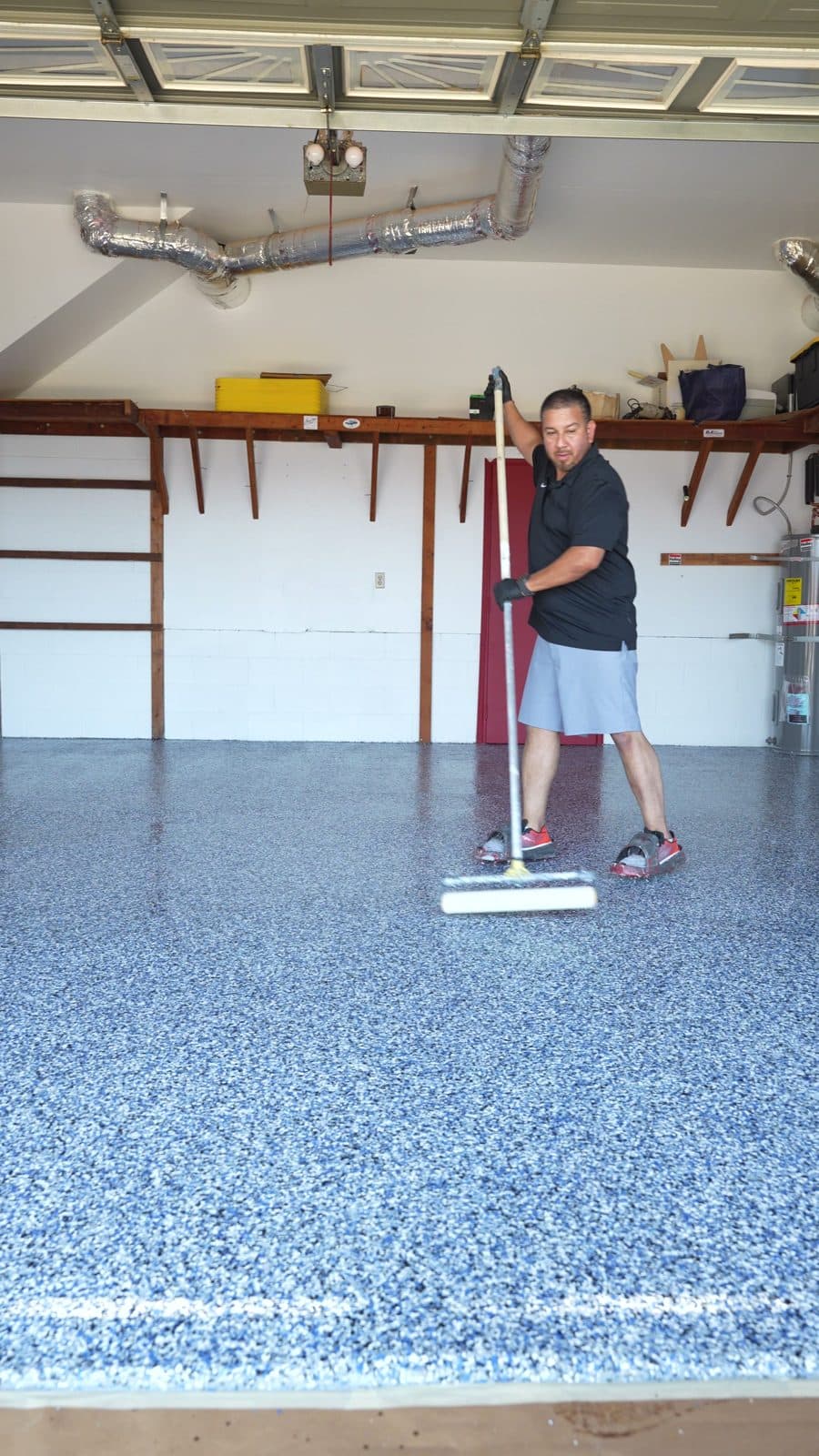 Back rolling the coating with a pole roller